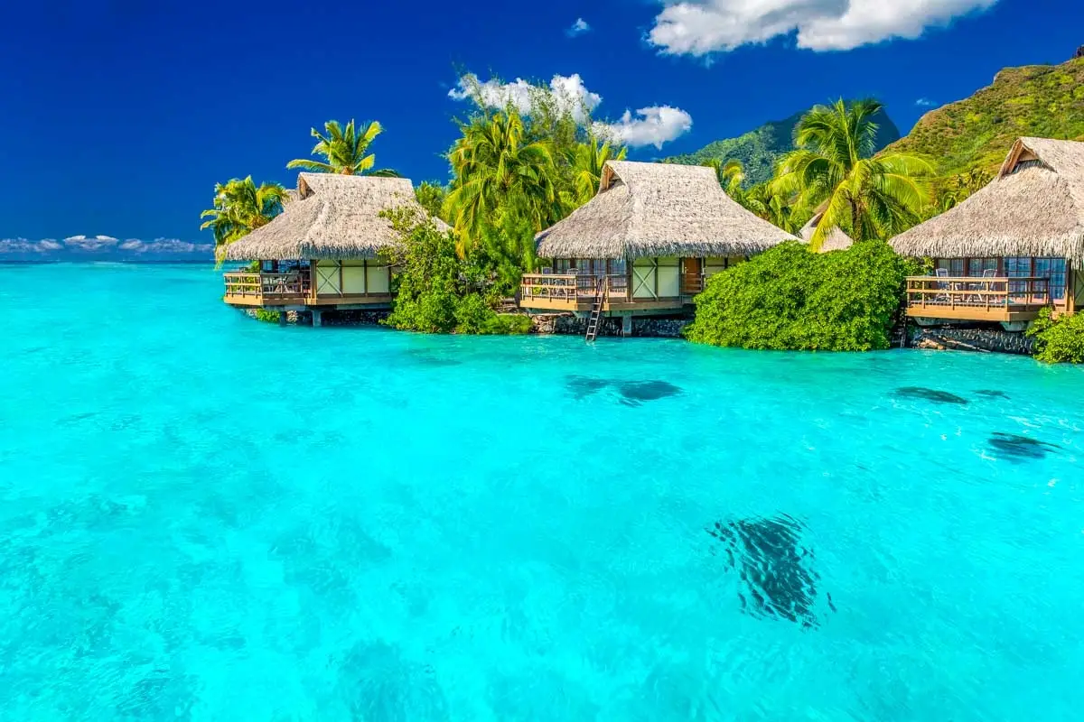 Overwater villas nestled in a turquoise lagoon in the South Pacific.