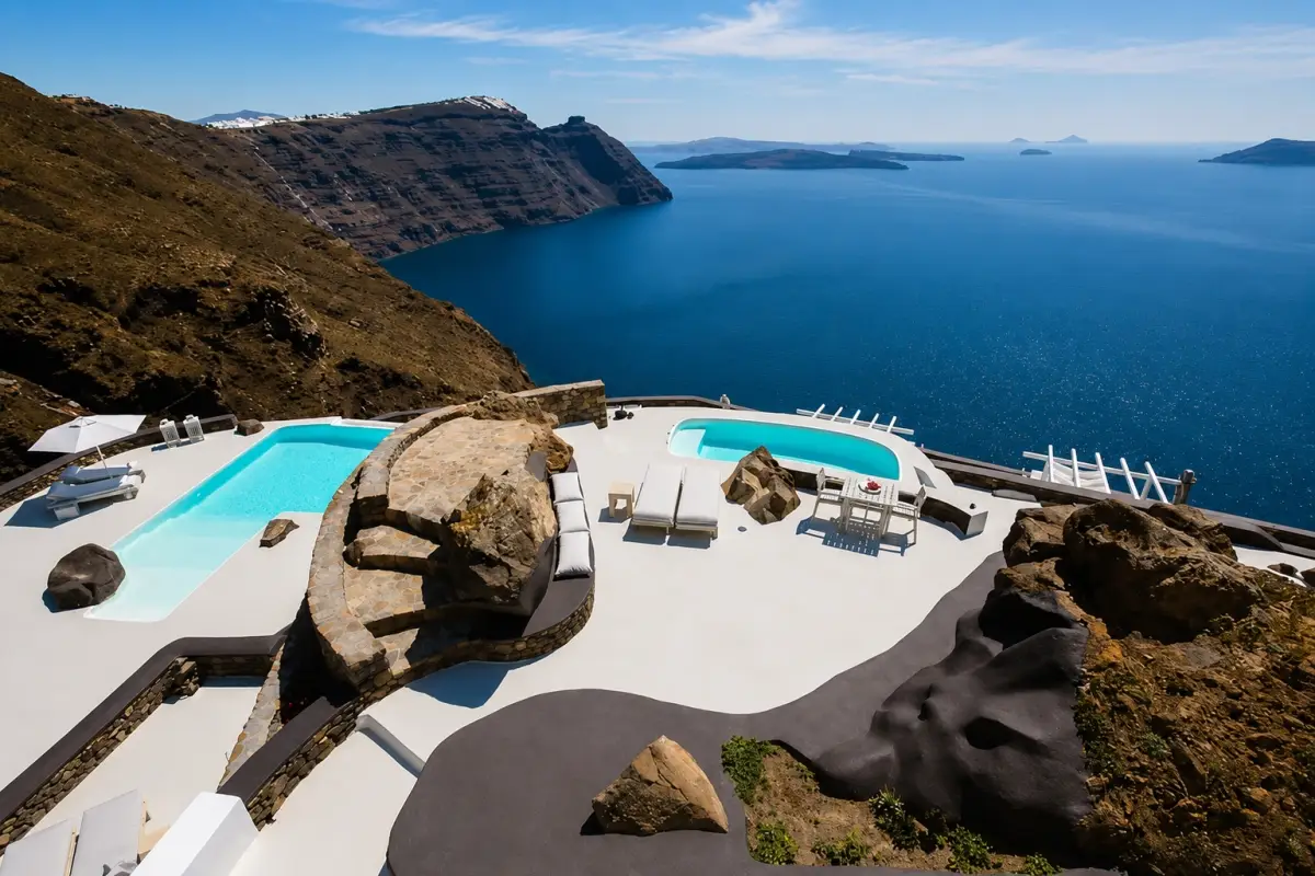 The Aenaon Villas in Santorini are perched on the cliffs of the Aegean caldera with multiple pools, private terraces and panoramic sea views.