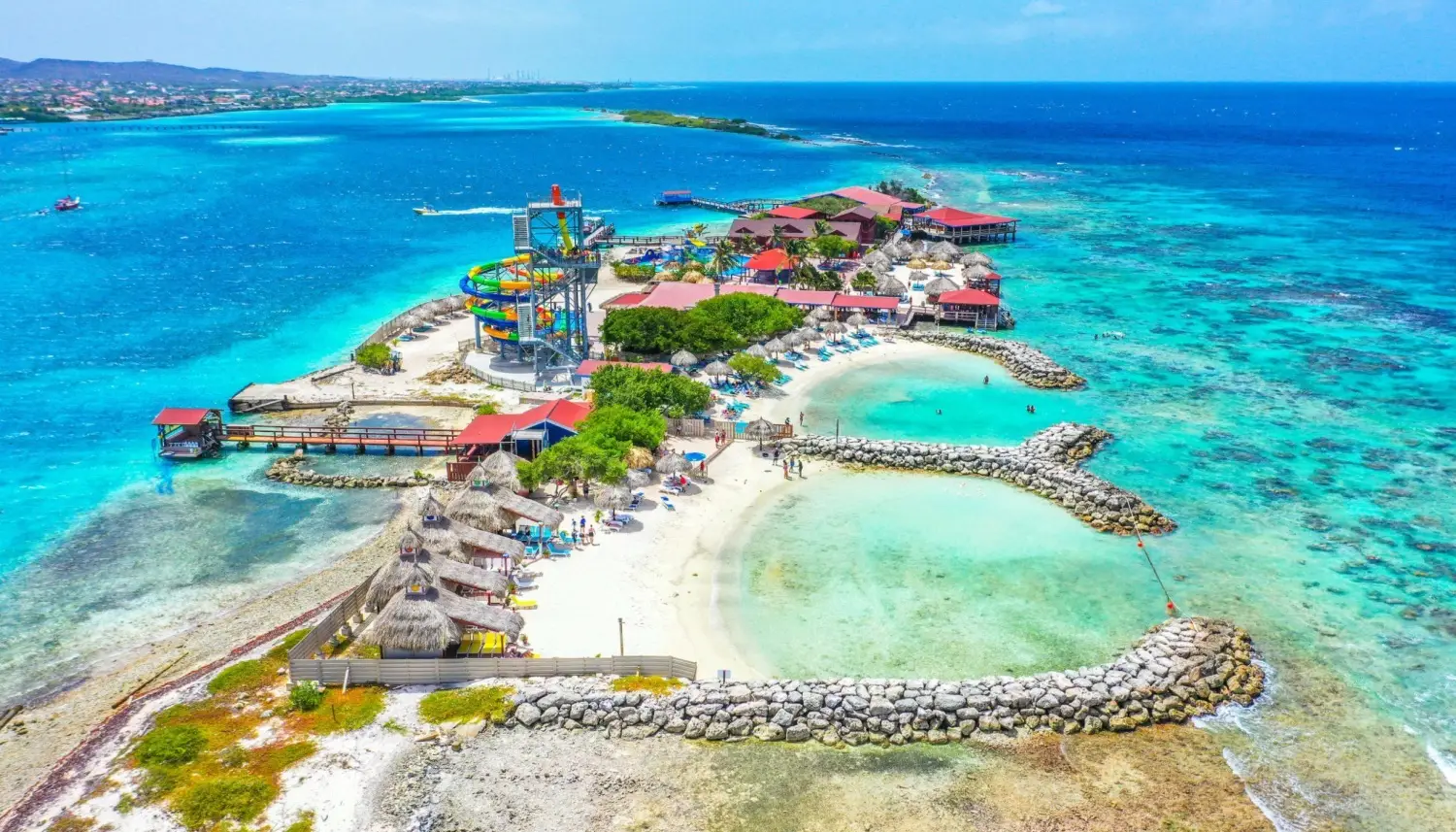 Scenic view of De Palm Island, a private all-inclusive island destination featuring water slides, a private beach, flamingo interaction areas, private cabanas and coral reef snorkeling areas.