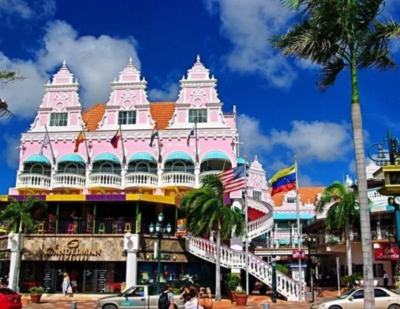 The bright pink Dutch Colonial architecture of the Royal Plaza Mall shopping center in downtown Oranjestad, Aruba.