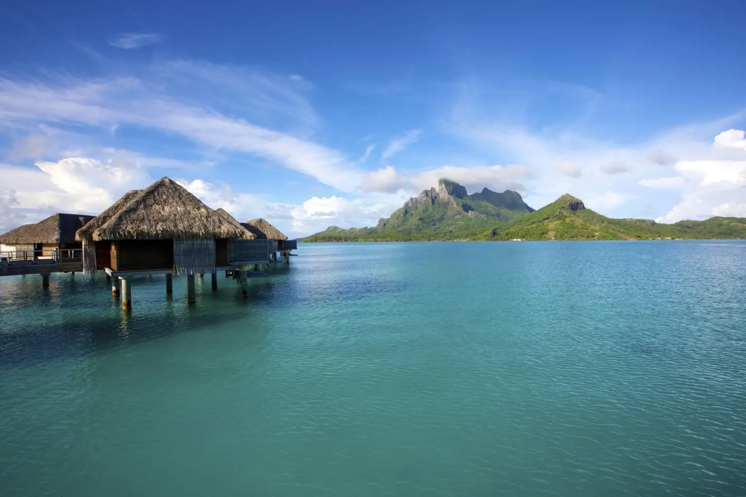 Overwater bungalows with a view of Mount Otemanu, Bora Bora.
