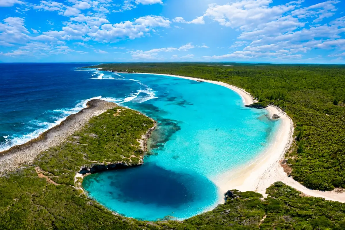 Located on Long Island near Clarence Town, Dean's Blue Hole is s sinkhole that sits just steps from a quiet white sand beach and creates a dramatic contrast against the shallow turquoise water surrounding it.