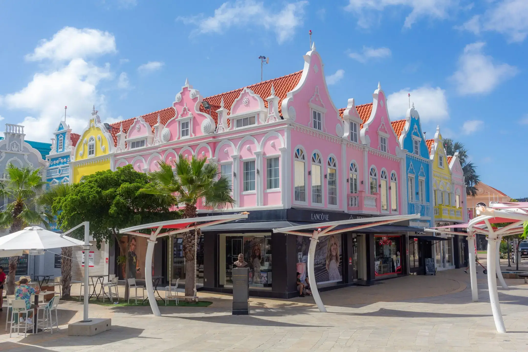 Vibrant pastel-colored buildings in Downtown Oranjested with a mix of designer boutiques, souvenir shops and cafes.