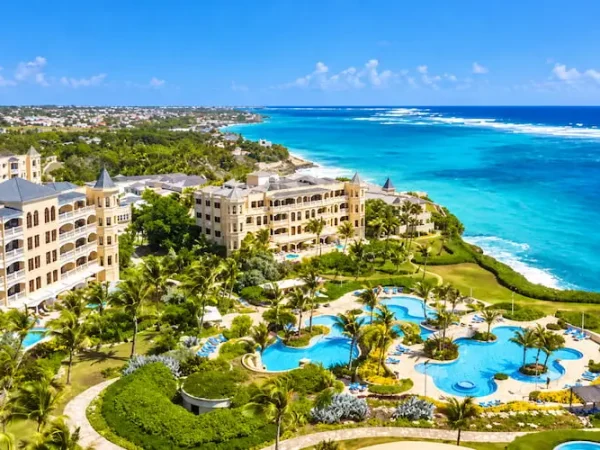 Aerial view of The Crane Resort cascading pools and historic suites on the coast of Barbados.