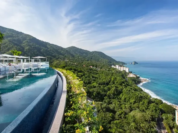 Rooftop infinity pool at Hotel Mousai in Puerto Vallarta overlooking the Sierra Madre jungle and Banderas Bay coastline.