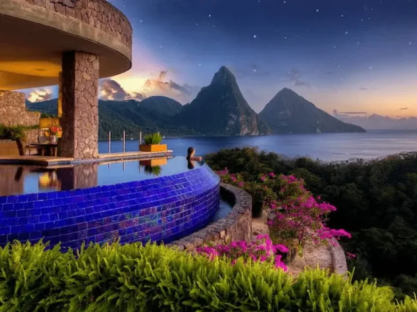 Luxury open-air infinity pool suite at Jade Mountain Resort overlooking the Piton mountains and ocean at twilight in Saint Lucia.