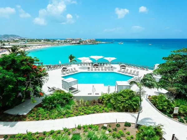 Sonesta Ocean Point Resort pool overlooking the turquoise ocean in Maho Reef, Sint Maarten.