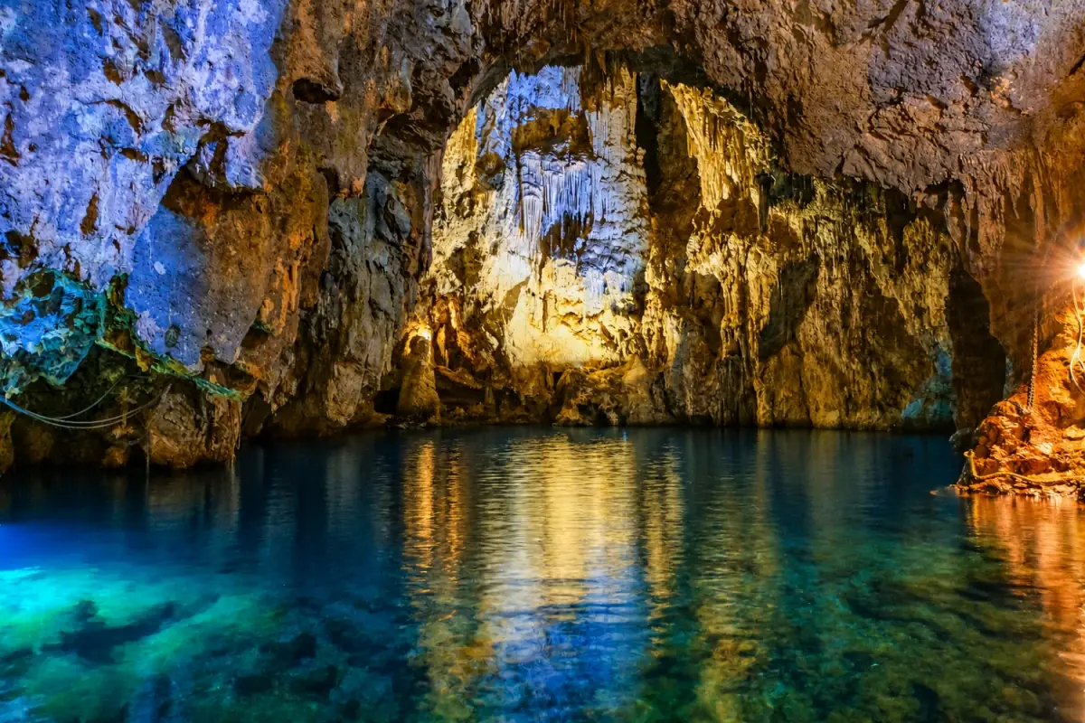 The Emerald Grotto is a sea cave famous for its glowing green-blue water, dramatic rock formations and magical underground atmosphere.