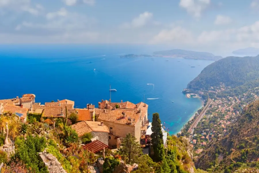 Panoramic view of the medieval hilltop village of Eze overlooking the blue Mediterranean Sea on the French Riviera.