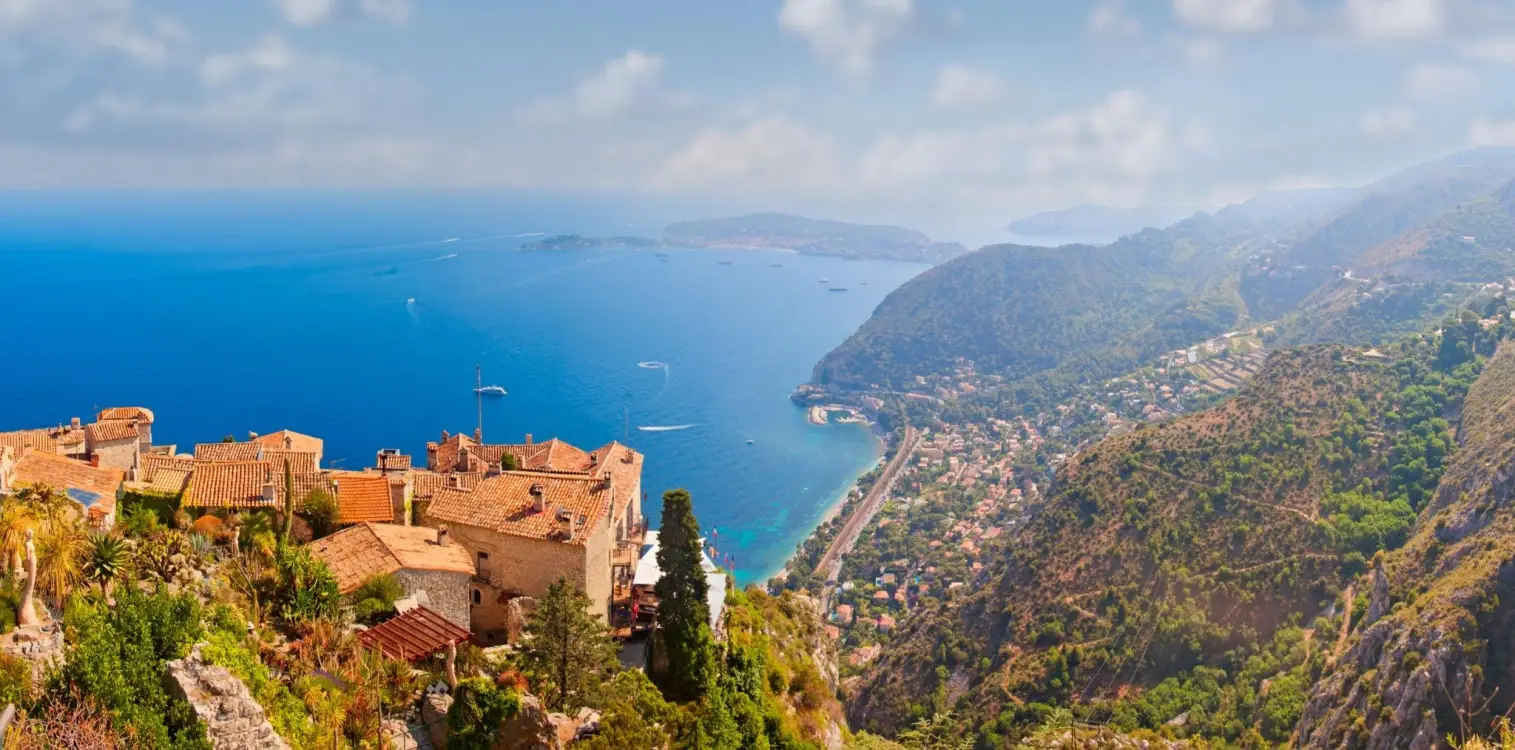 Bird's-eye view of the medieval hilltop village of Èze, showcasing traditional stone buildings overlooking the blue waters of the French Riviera