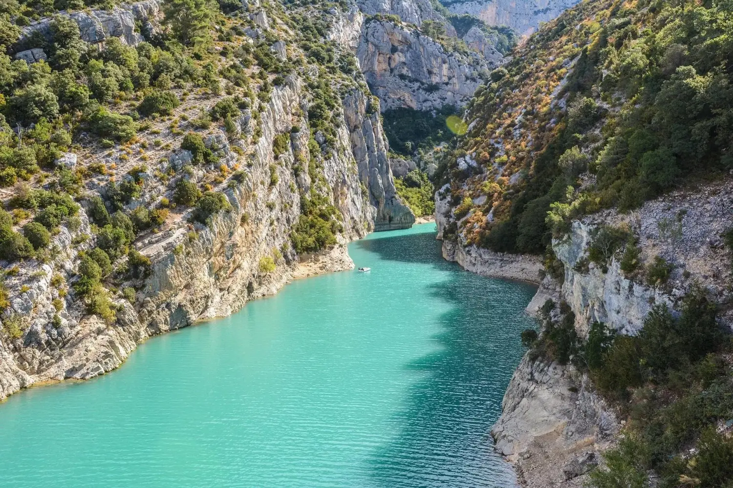 Panoramic view of the turquoise Verdon River flowing through a steep canyon into Lake of Sainte-Croix in France.