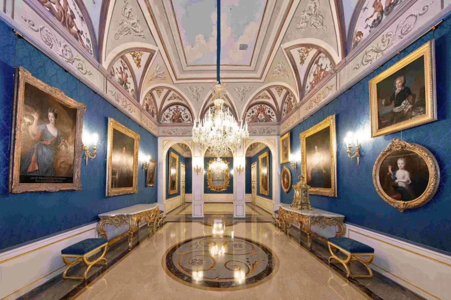 Interior view of the blue walls and ornate gold frames within the Blue Matignon Salon at the Prince's Palace of Monaco, French Riviera.