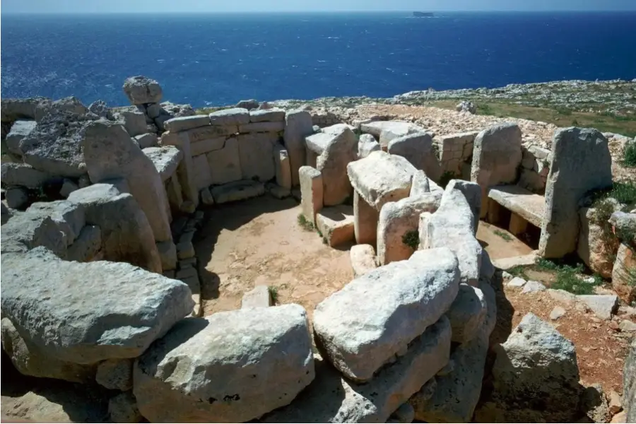 Prehistoric Mnajdra megalithic temple ruins overlooking the Mediterranean Sea coast in Malta.