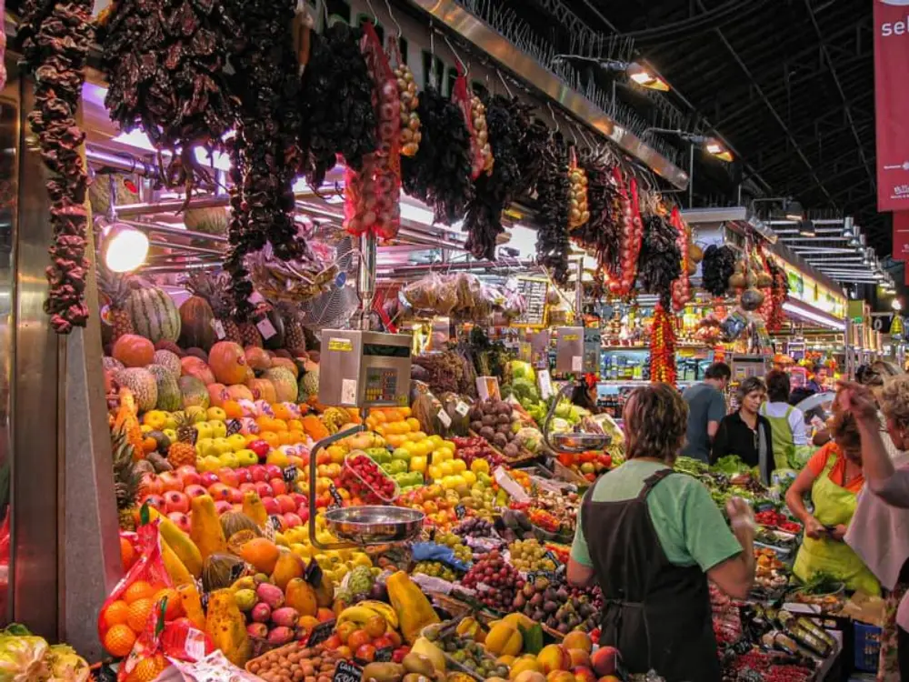 In the middle of Barcelona’s famous La Rambla, Mercat de Sant Josep de la Boqueria, known simply as La Boqueria, bursts with color, aroma, conversation, and the unmistakable energy of a working food market.