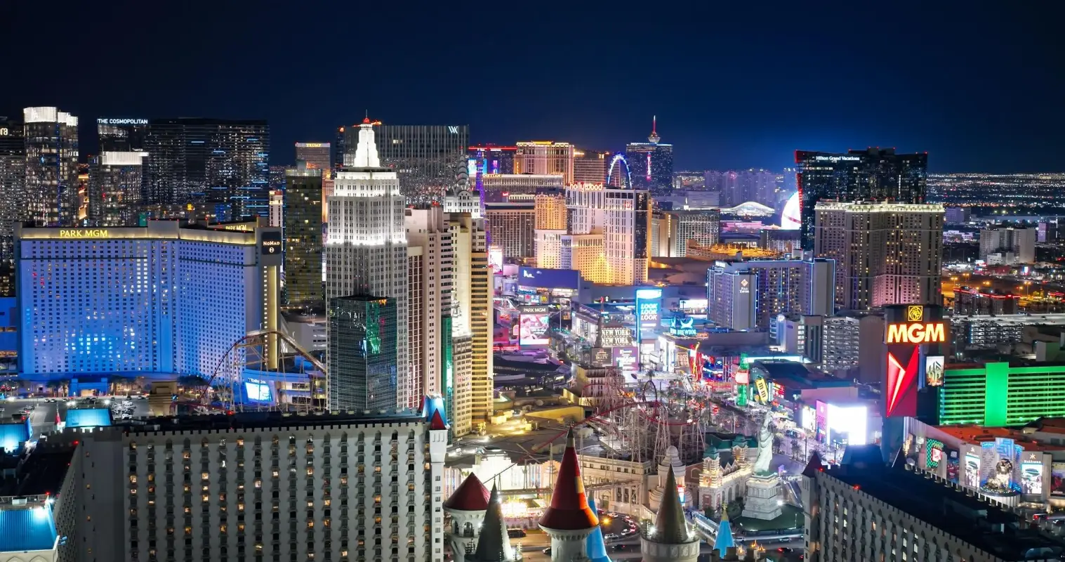 A nighttime view of the Las Vegas Strip, focusing on several iconic resorts.