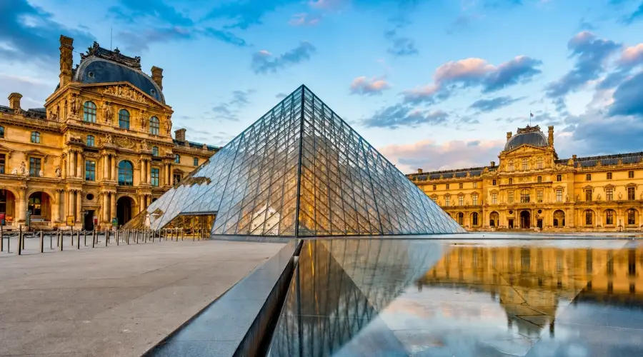 The Louvre Pyramid, a large glass and metal structure designed by architect I.M. Pei that serves as the main entrance to the Louvre Museum in Paris.