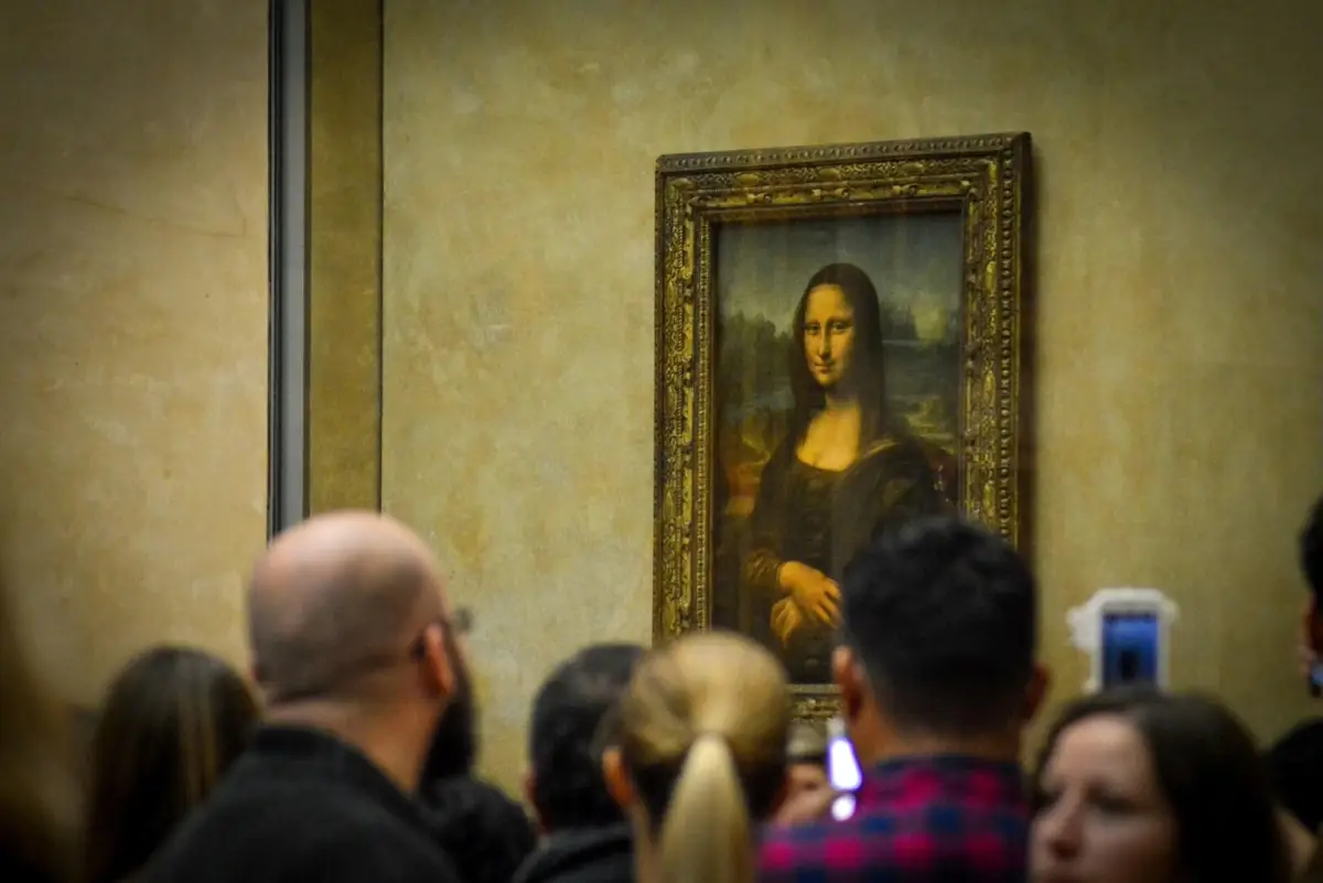The Mona Lisa, a famous portrait painted by Leonardo da Vinci between 1503 and 1519, displayed at the Louvre Museum in Paris, France.