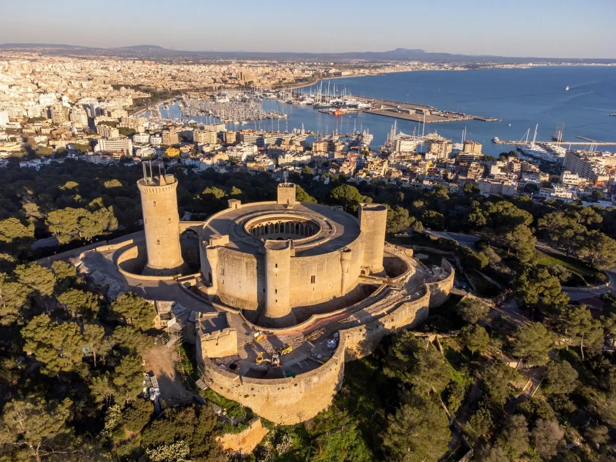 Aerial view of Bellver Castle, a unique circular Gothic style fortress located in Palma, Mallorca, Spain, offering panoramic views of the city and the Bay of Palma.