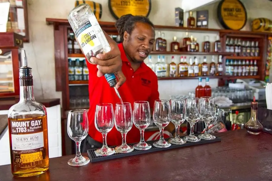 Bartender pouring Mount Gay Rum during a tasting experience at the Mount Gay Rum Distillery in Barbados.
