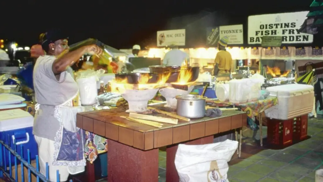 Oistins Fish Fry in Barbados is a popular social gathering featuring freshly cooked local fish, lively music, and a party atmosphere famous for its bustling atmosphere on Friday nights.