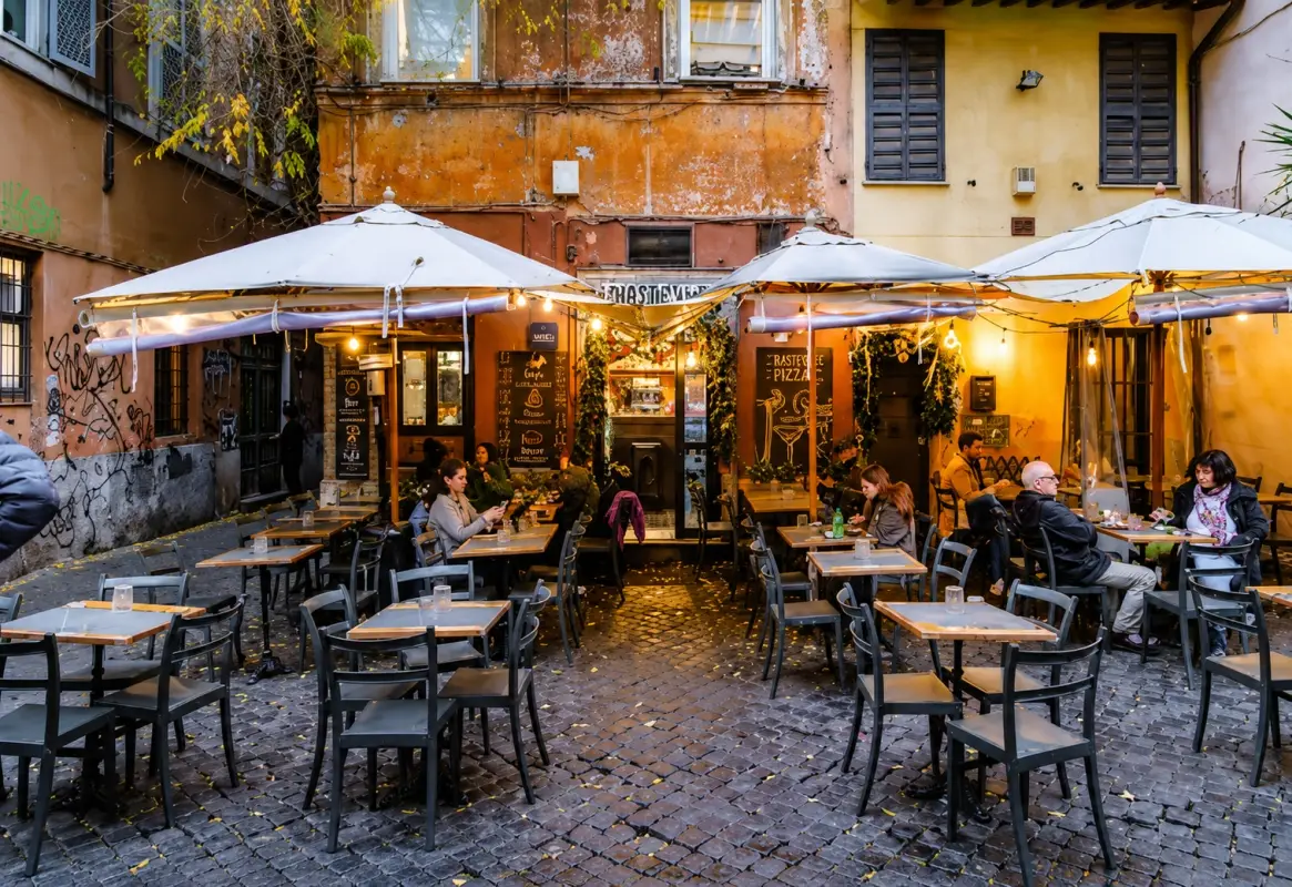 A charming outdoor cafe in a historic Italian neighborhood.