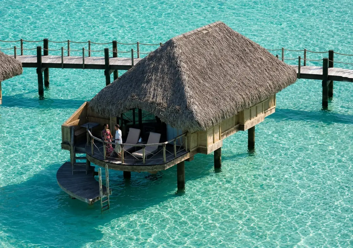 Signature overwater bungalow at Le Bora Bora by Pearl Resorts.
