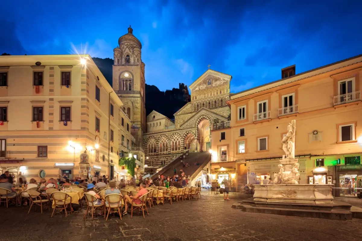 Piazza Duomo in Amalfi, Italy, highlighted by the ornate facade and staircase of the Amalfi Cathedral.