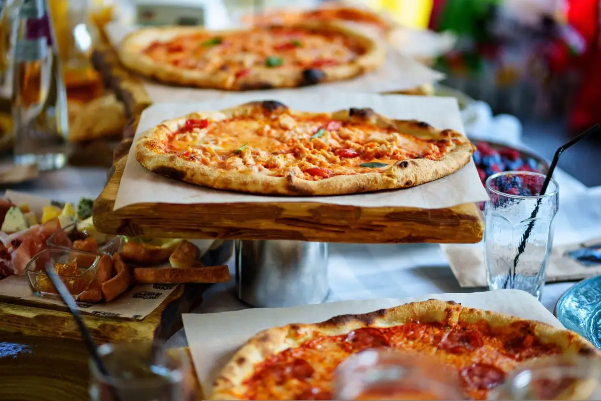 Roman pizza with cheese, sausage, and tomatoes.