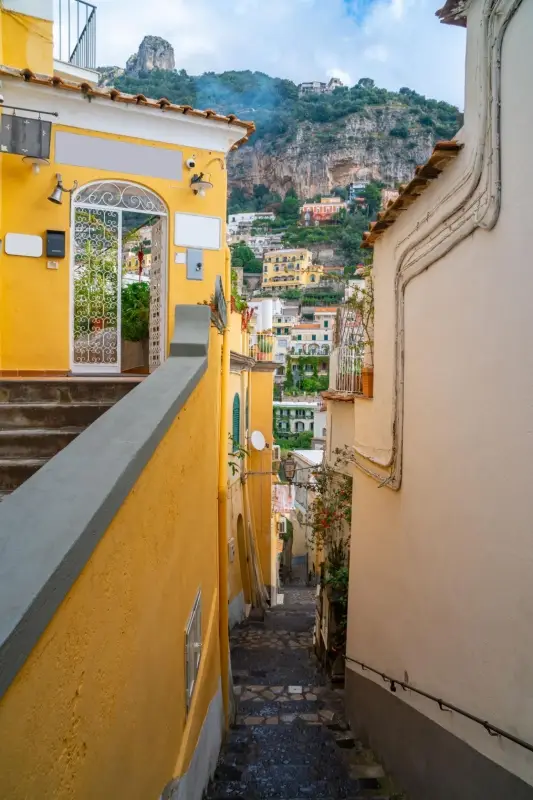 A narrow street in Positano, a picturesque town renowned for its colorful buildings on the Amalfi Coast.