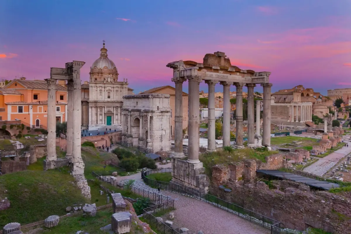 The ancient ruins of the Roman Forum in Rome, Italy, captured during sunset.