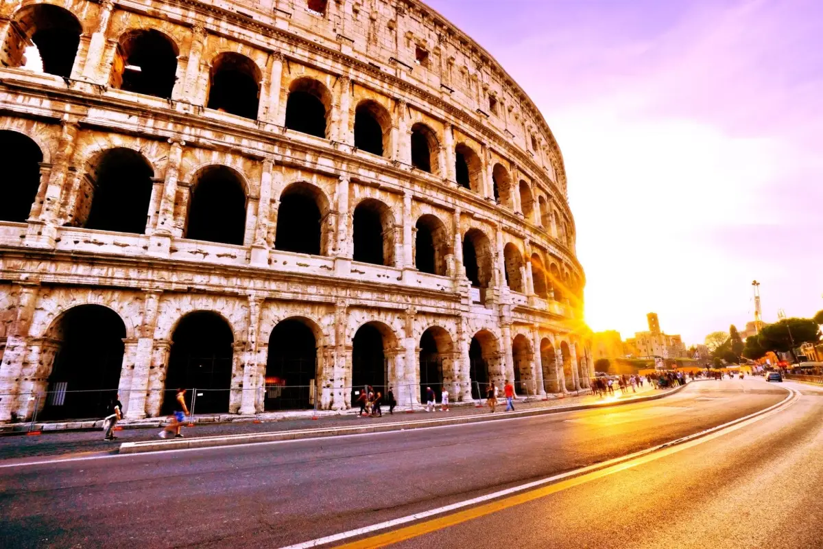A dramatic view of the Rome Colosseum at sunset.