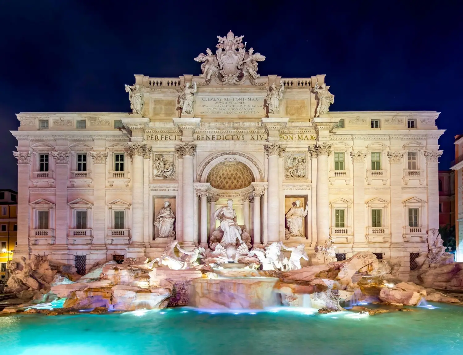 Trevi Fountain in Rome, Italy, a Baroque masterpiece featuring the illuminated sculpture of Oceanus and sea horses.