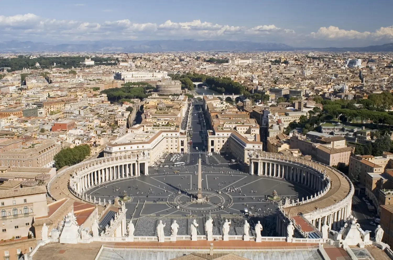Panoramic view of St. Peter's Square and Rome skyline from the Vatican Basilica dome.