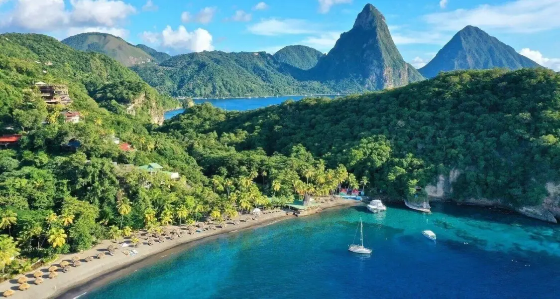 Anse Chastanet beach and marine reserve resort coastline with the iconic Pitons rising in southwestern Saint Lucia.