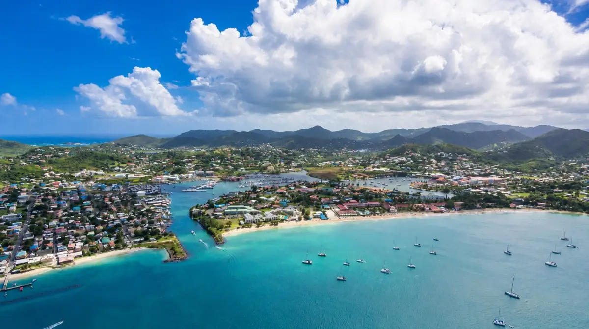 Saint Lucia’s Rodney Bay and Reduit Beach aerial view featuring a tropical lagoon, boats in turquoise Caribbean waters, and seaside resorts.