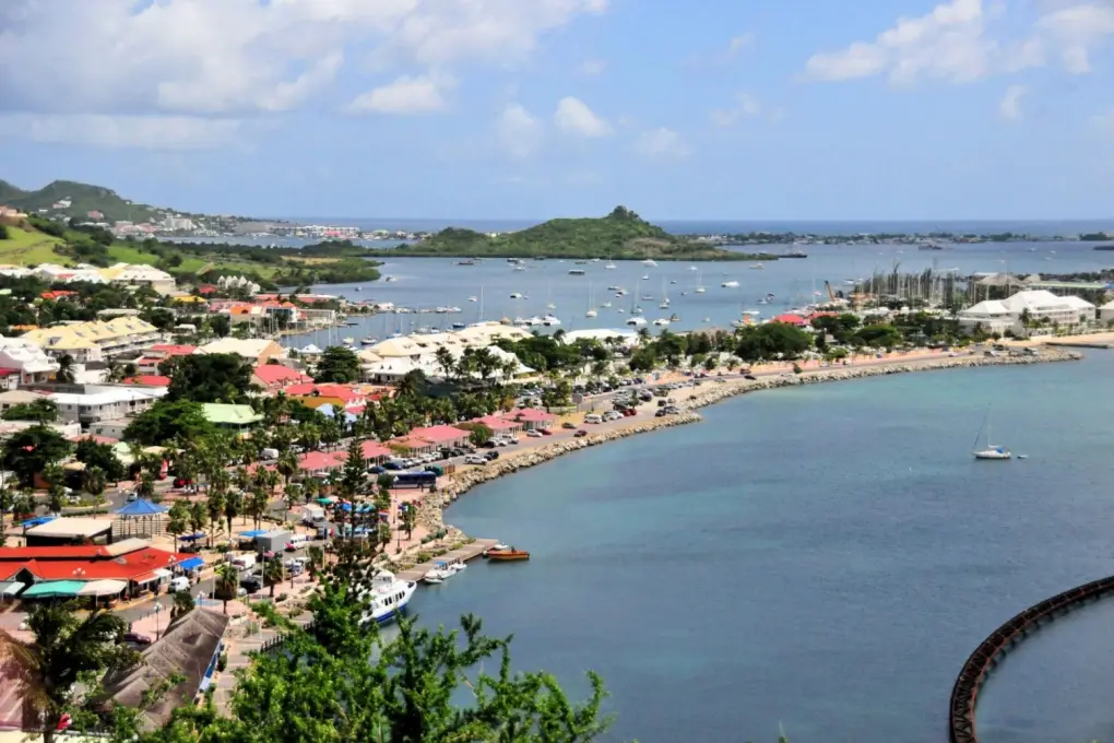 Aerial overlook of Marigot bay and harbor in Saint Martin under a blue sky.