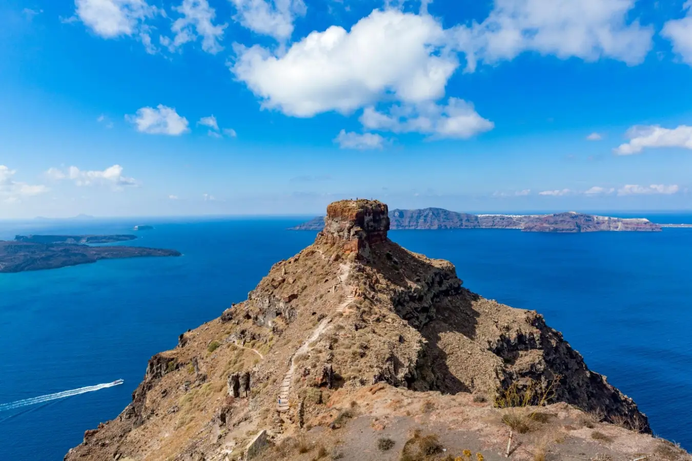 Scenic view of Skaros Rock trail in Santorini Greece under a blue sky.