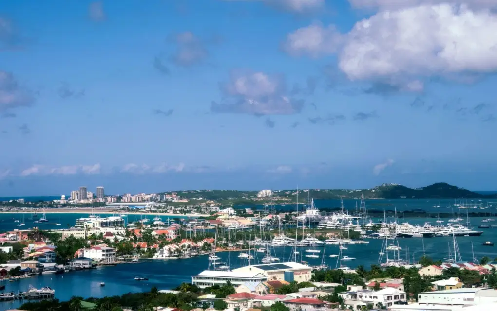 Elevated viewpoint overlooking the harbor, boats, and waterfront town at Simpson Bay, St. Maarten.