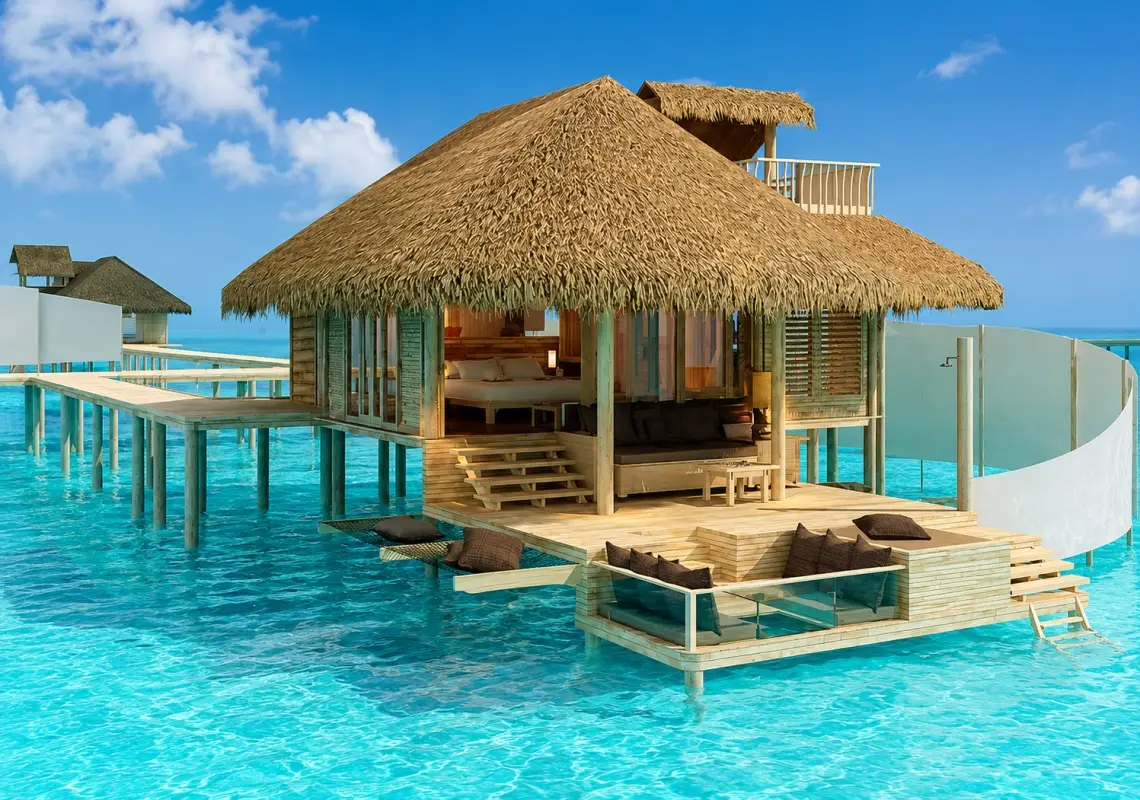 An overwater villa at the Six Senses Laamu in the Maldives includes a private deck with outdoor lounging areas and direct access to the ocean.