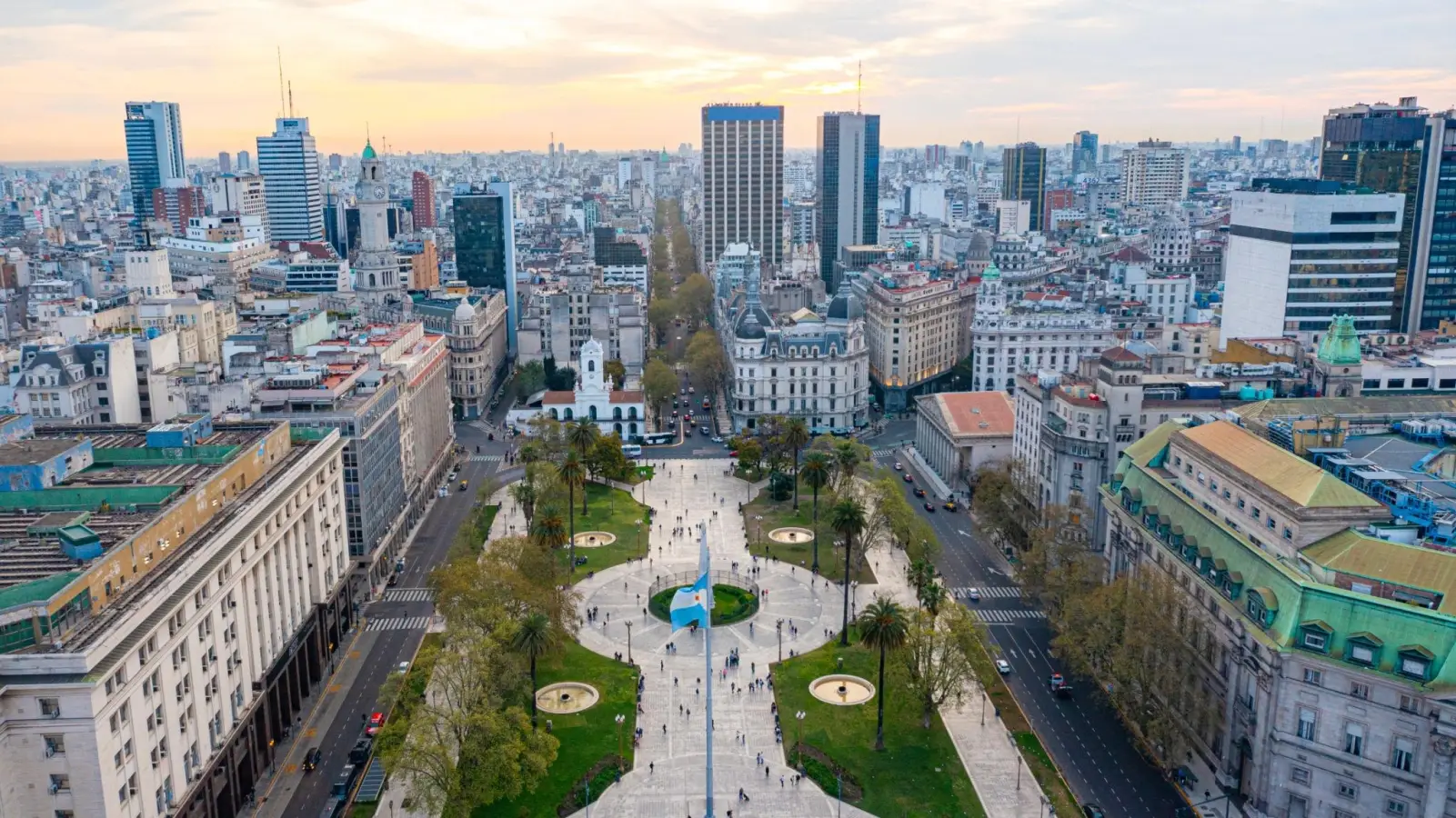Aerial view of Plaza de Mayo in Buenos Aires Argentina featuring historic buildings and a giant national flag.