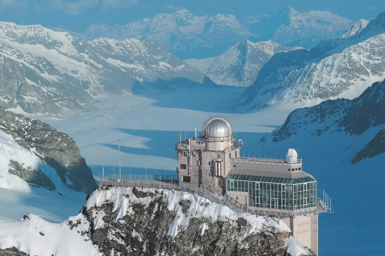 High in the Bernese Alps, between the towering peaks of Jungfrau and Monch, Jungfraujoch is a dramatic alpine ridge featuring the Sphinx Observatory.