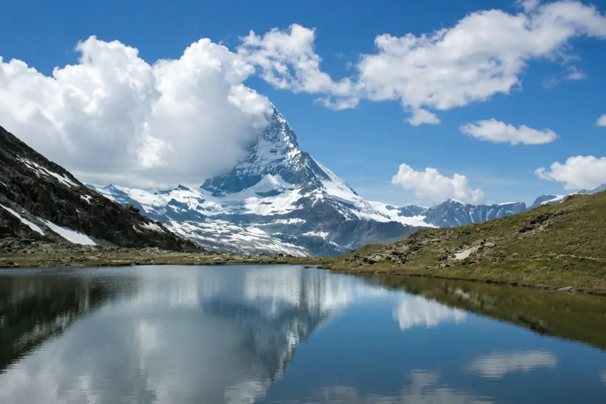 Matterhorn mountain peak reflected in the clear water of Riffelsee Lake near Zermatt, Switzerland.