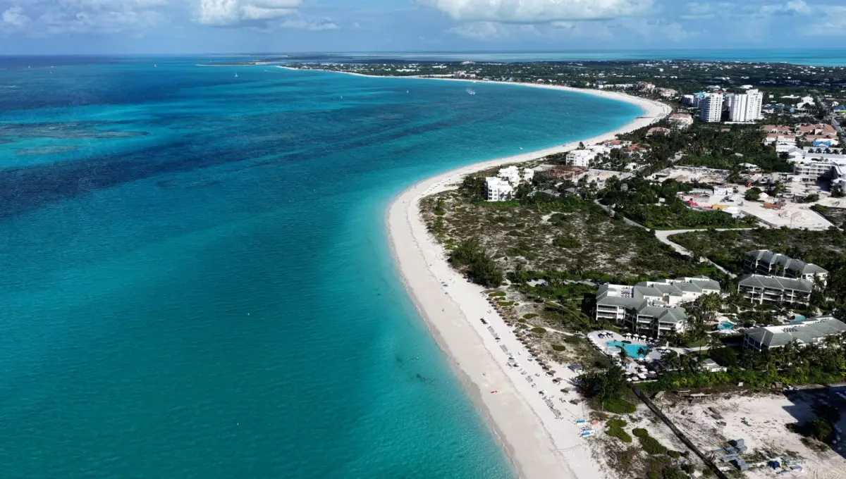 Panoramic overhead view of the white sands and crystal clear ocean at Grace Bay Beach.